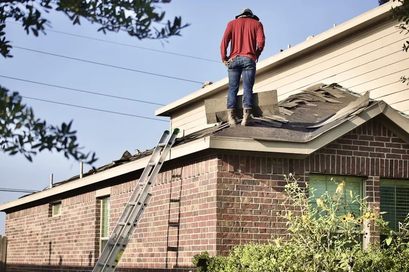 Professional roofer working on a residential roof in St. Ann